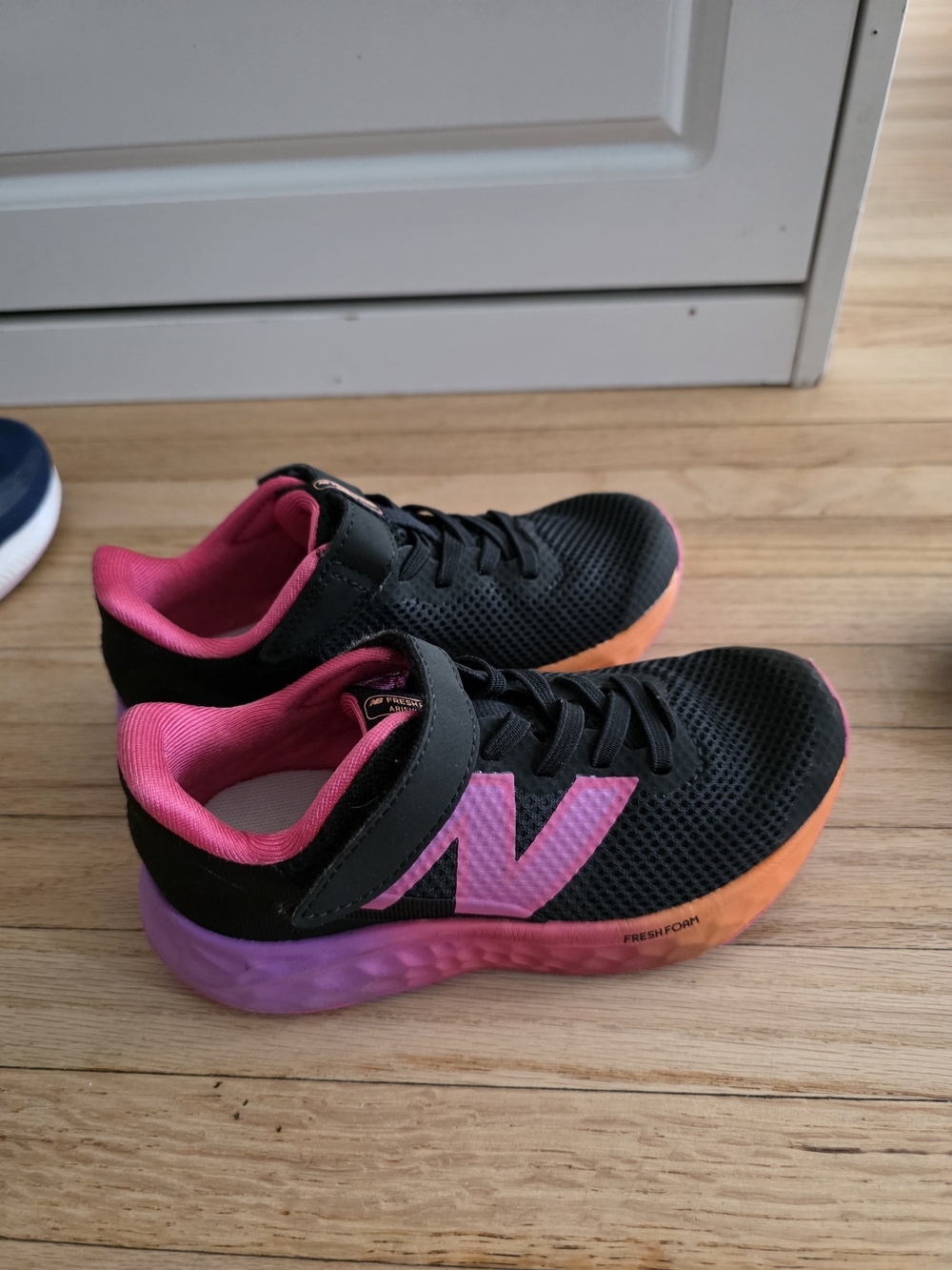 New Balance Kids Black Sneakers with Pink 'N' and Orange Gradient Sole